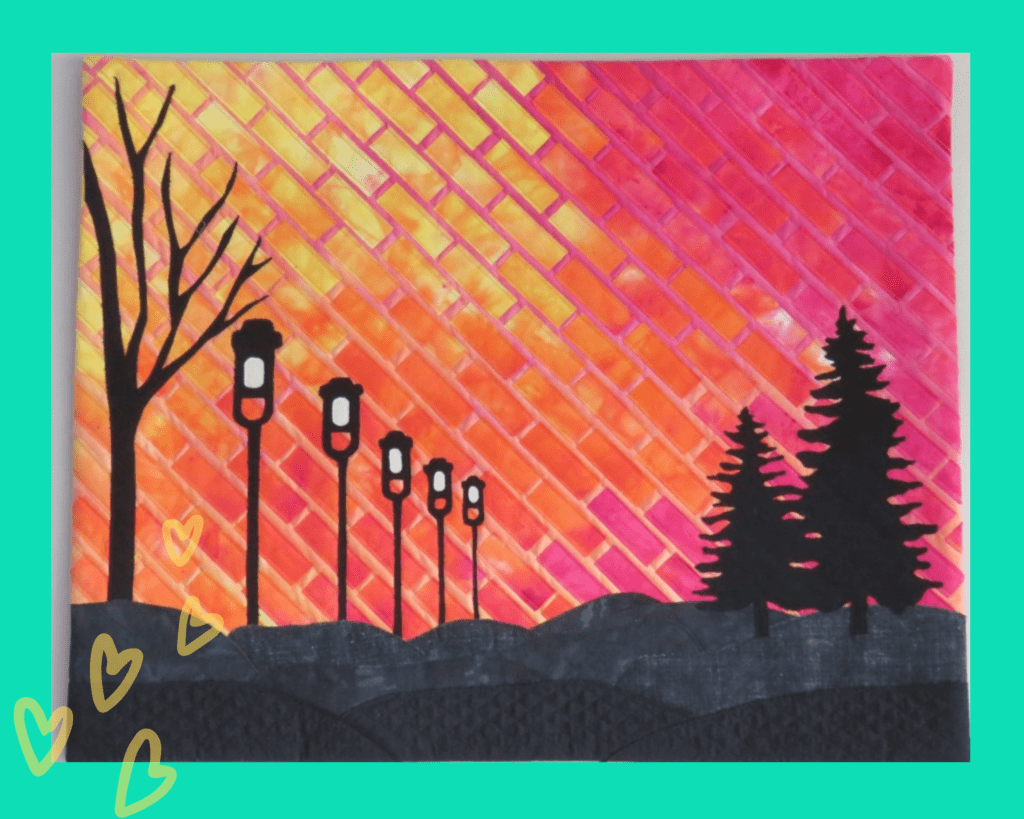 art quilt with orange and pink background and silhouette of trees and lamp posts made by Make Modern Triangles member.