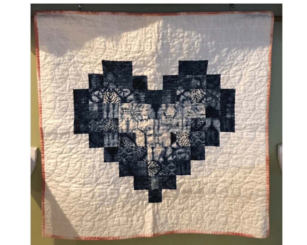 Heart-shaped block quilt design made by Make Modern Triangles member Lillian N.