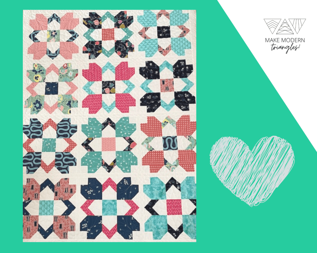 Make Modern Triangles featured member photo of a traditional quilt with with muted, tonal pinks, greens, reds and blues.