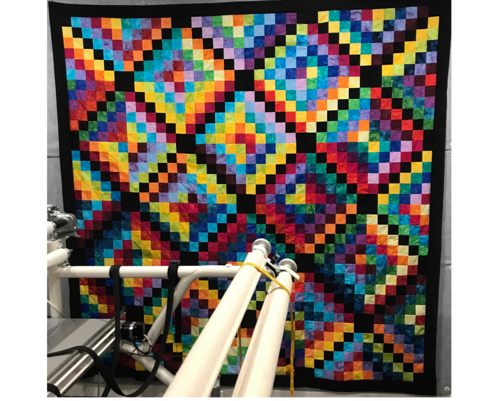 Colorful Quilting Around the World design made in a rainbow color palette.