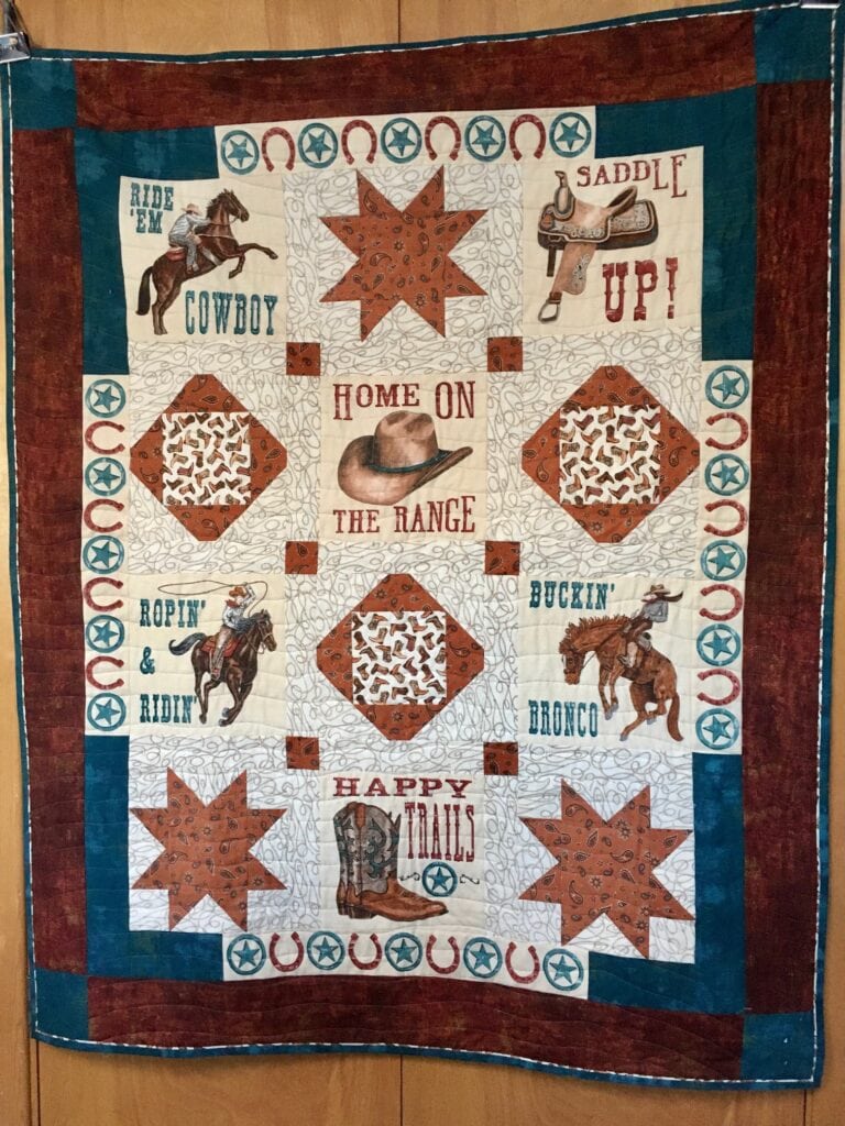 Member spotlight gallery features a cowboy-themed quilt made by Lonnie.