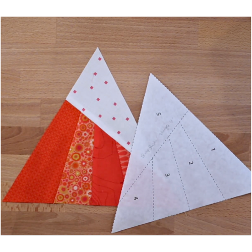Scrappy whirligig block completed and foundation made with freezer paper