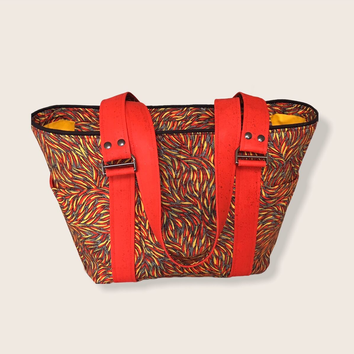 Member spotlight gallery features a red, green and gold patterned bag made by Lonnie W.