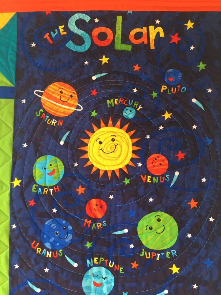 Member spotlight gallery features a colorful child's quilt of the solar system.