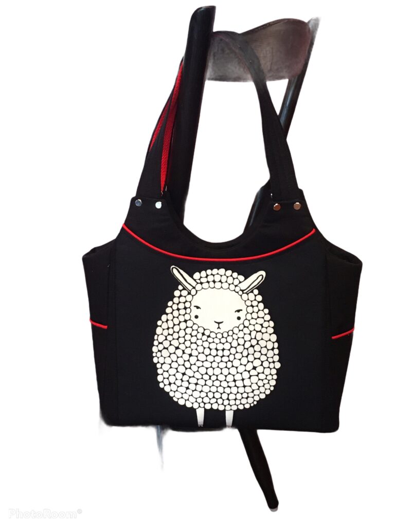 Member spotlight gallery features a black and red bag with a sheep motif made by Lonnie.