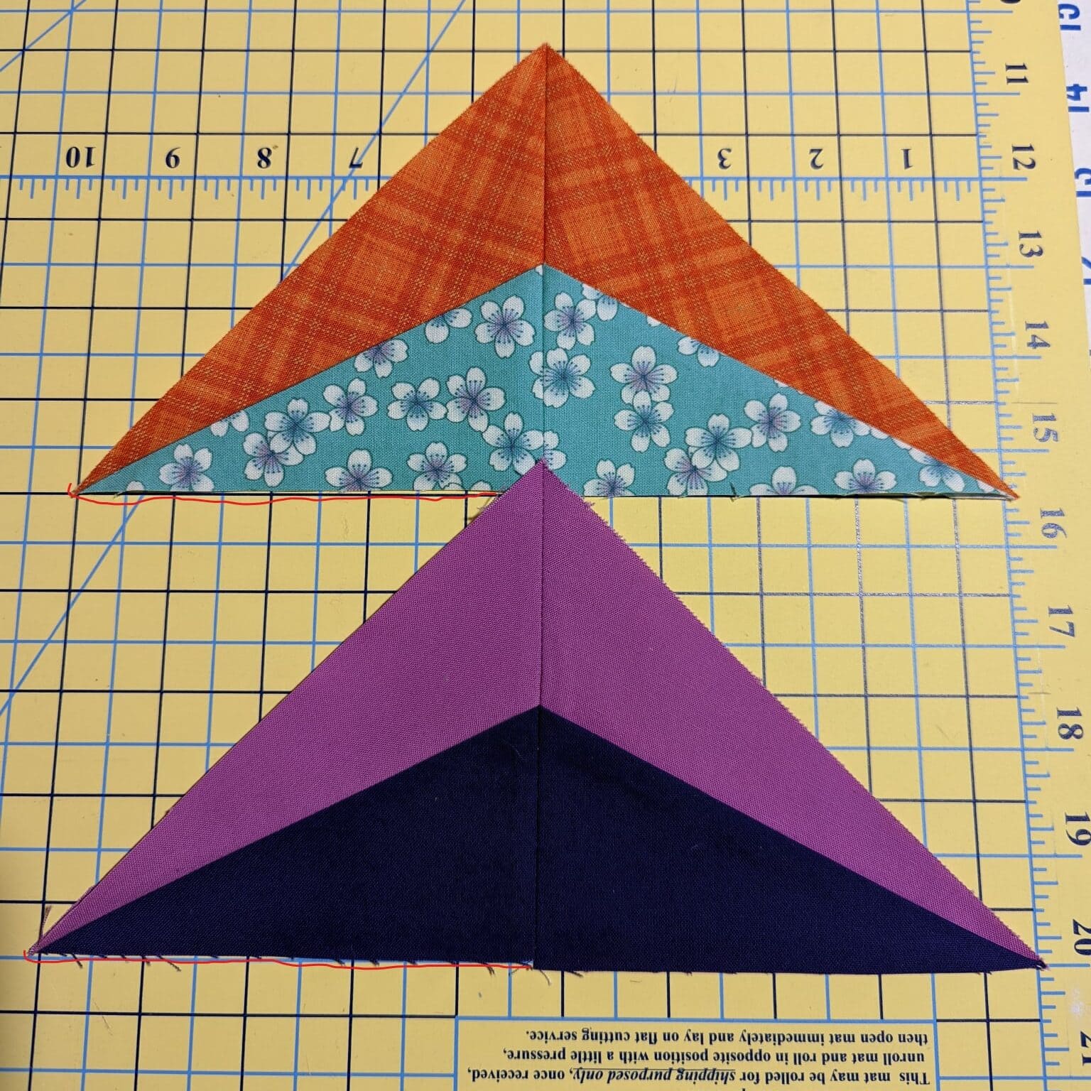 Sparkler BOM Month 2 block made with purple and dark navy fabrics plus a test block in orange and teal fabrics.