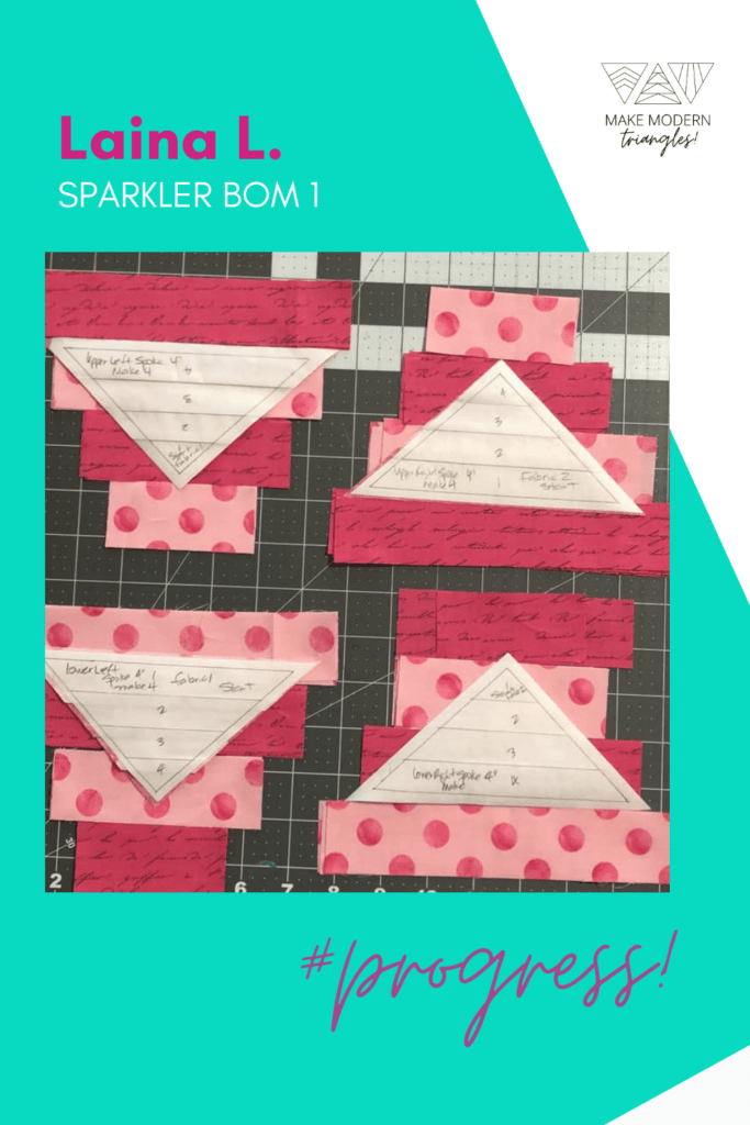 Sparkler BOM month 1 triangle blocks sewn in strip sets in red and pink fabrics.