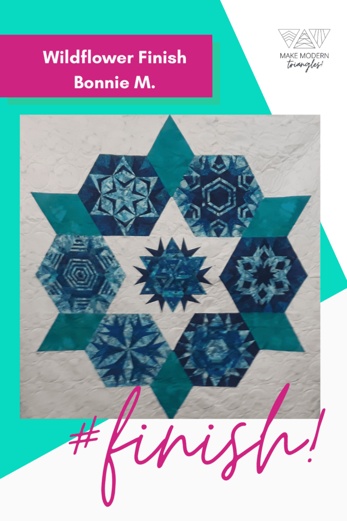 Wildflower modern triangle quilt made by a Make Modern Triangles member in blue and teal fabrics.