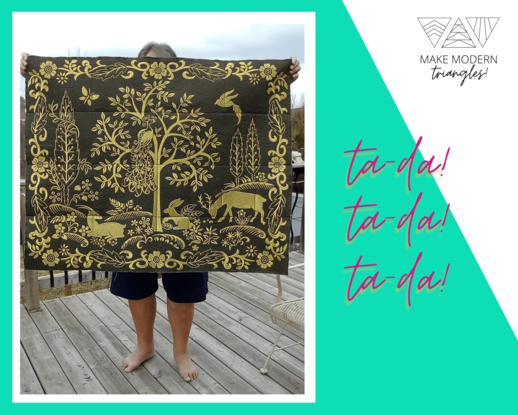 Featured spotlight Make Modern Triangles member Shirley M. shows her applique quilt in black and gold colors.