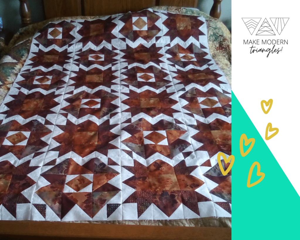 High contrast white and brown half square triangle blocks quilt made by Shirley M., Make Modern Triangles member.