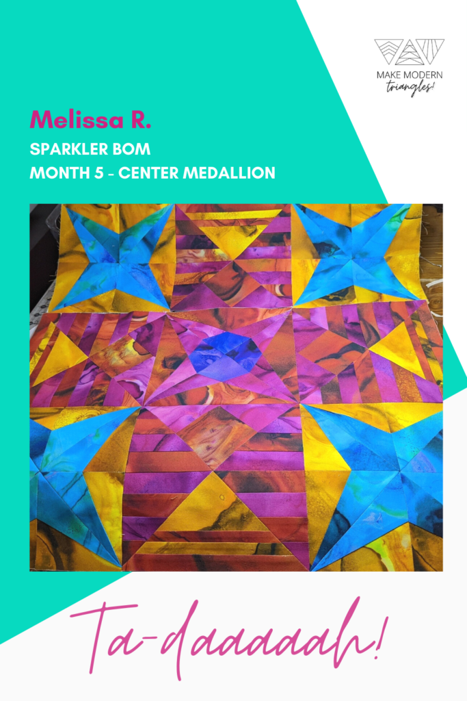 Sparkler BOM 5 center medallion in intensely colored fabrics - magenta, gold, yellow, blue and reds.