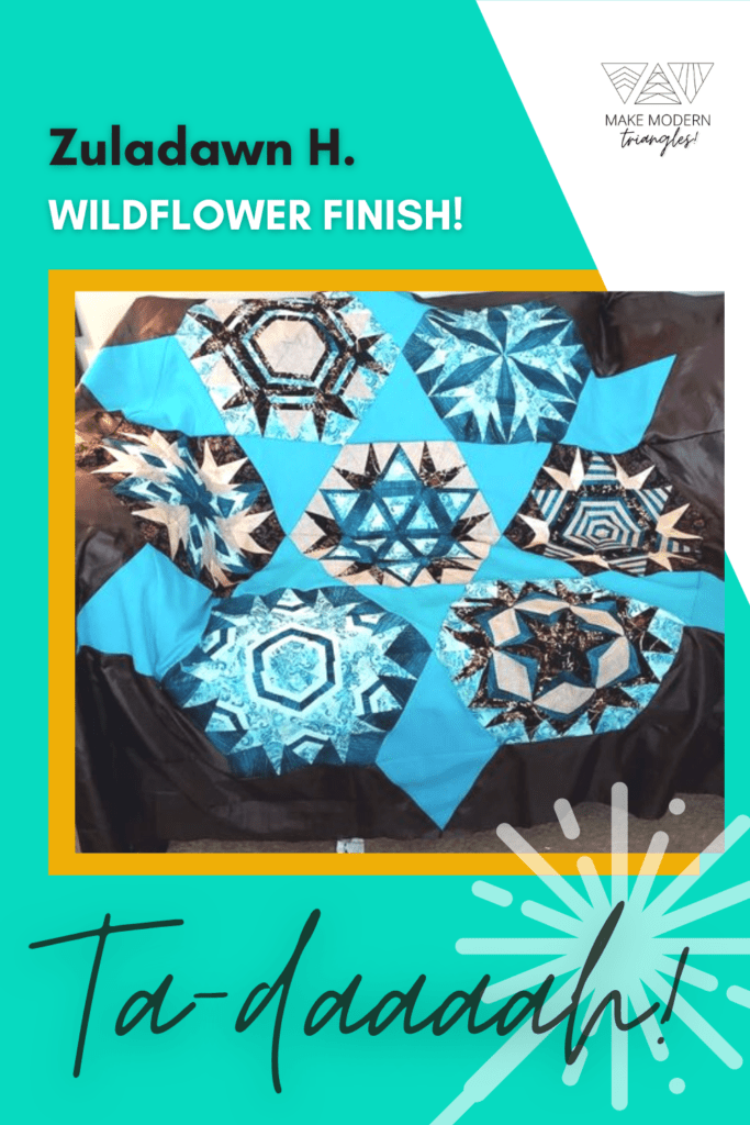 Make Modern Triangles member Zuladawn H. finished a Wildflower BOM quilt. Blue, teal, navy and light blue fabrics form seven triangle blocks.