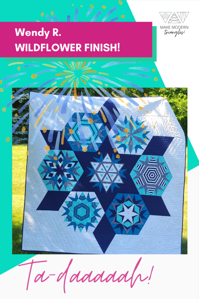 Make Modern Triangles member Wendy R. finished a Wildflower BOM quilt. Blue, teal, navy and light blue fabrics form seven triangle blocks.