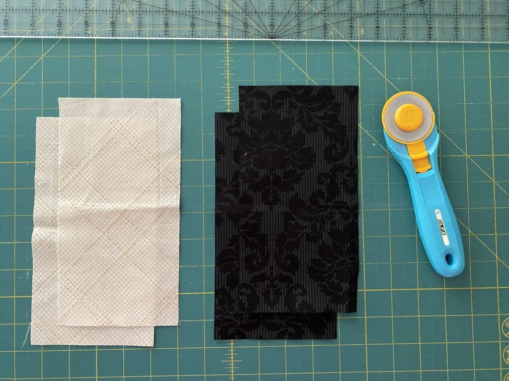 Cutting mat with fabric that will be cut to make the eyes for the Boos and Ghouls quilt