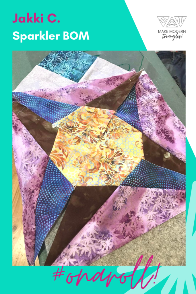 Sparkler BOM made by Jakki C. in purple, blue, yellow and brown batik fabrics.