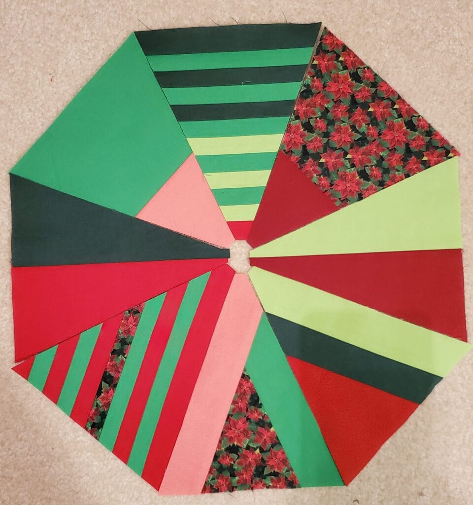 Member Annette H. arranged her triangle tree blocks in a circular pattern including Day 3 striped blocks.