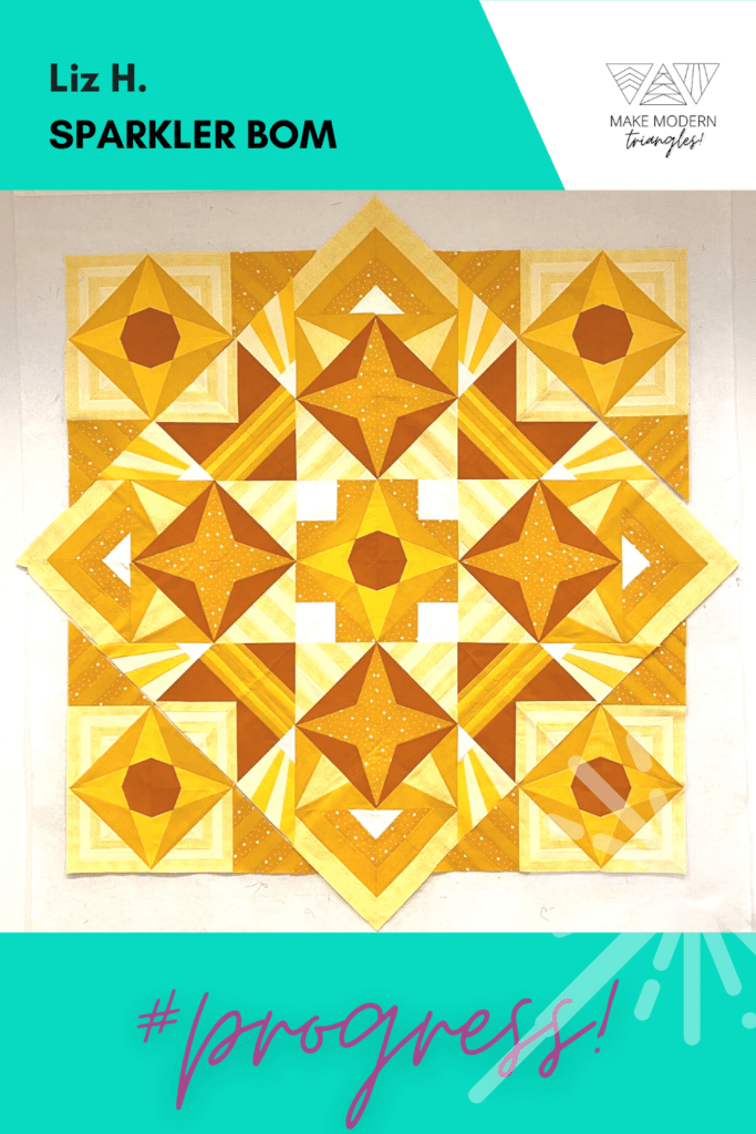 Sparkler BOM quilt made by Make Modern Triangles member Liz H. in yellows and oranges.