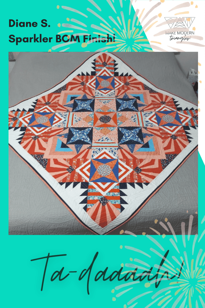 Sparkler BOM quilt made by Make Modern Triangles member Diane S.in orange and blue fabrics.