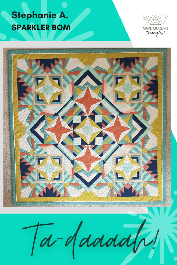 Sparkler BOM quilt made by Make Modern Triangles member Stepahnie A. in orange, yellow and green  fabrics.