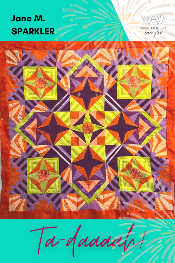 Sparkler BOM quilt made by Make Modern Triangles member Jane M. in orange, yellow and purple fabrics.