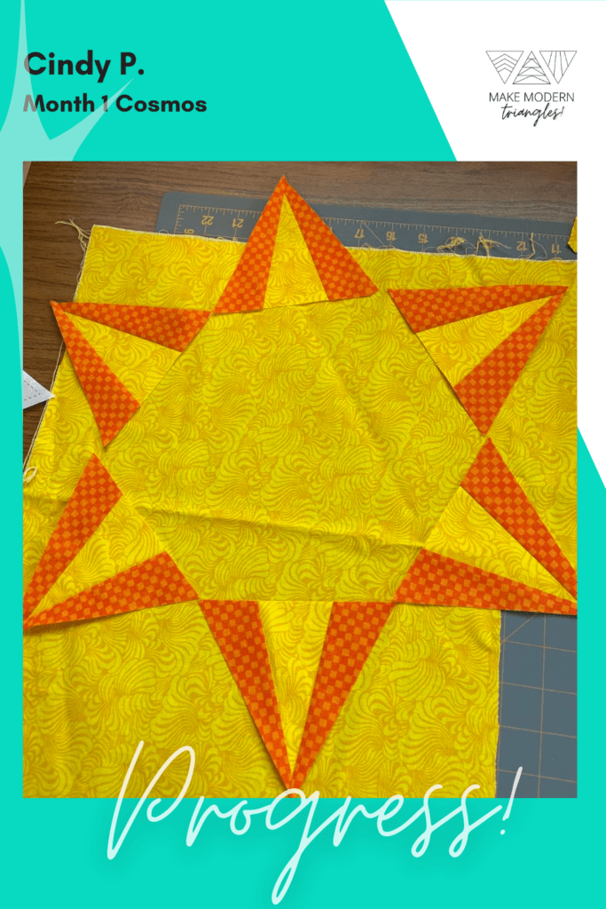 Cosmos BOM month 1 blocks completed by Make Modern Triangles member in yellow and orange fabrics.