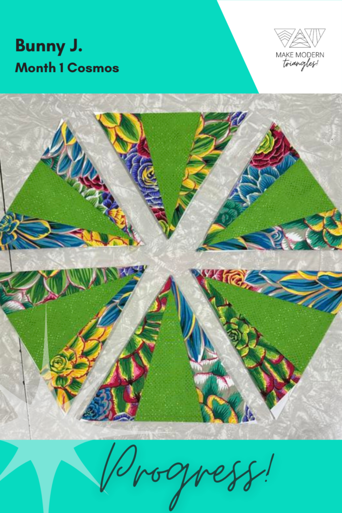 Cosmos BOM month 1 blocks completed by Make Modern Triangles member in bright green and multi-colored print fabrics.cor