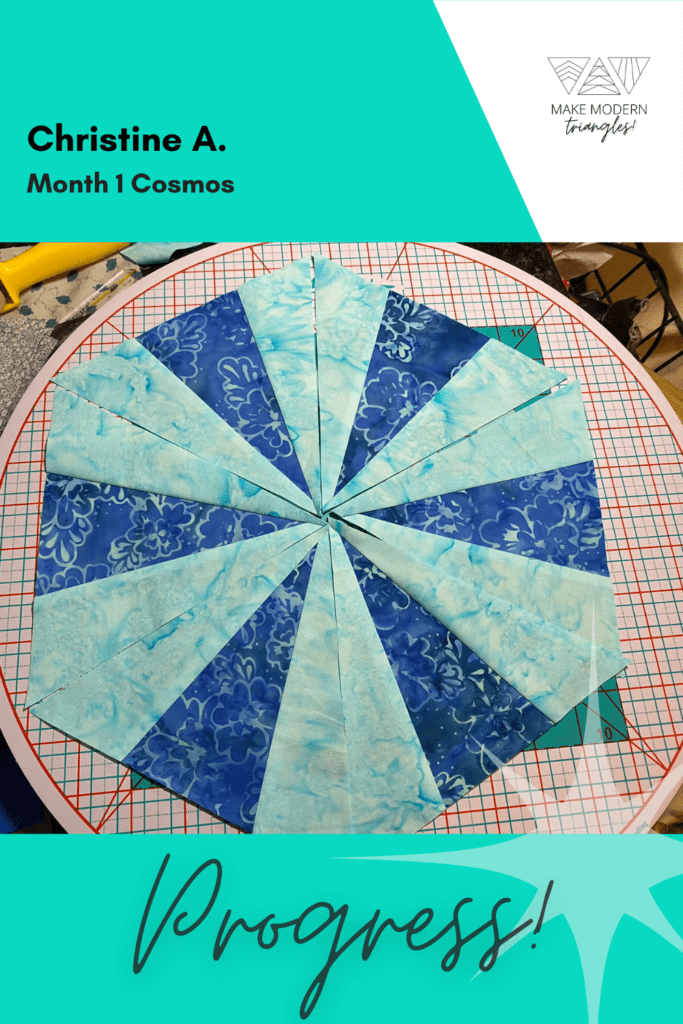 Cosmos BOM month 1 blocks completed by member in teal and royal blue batik fabrics.