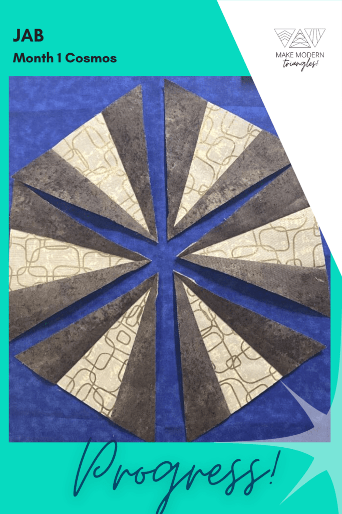 Cosmos BOM month 1 blocks completed by Make Modern Triangles member in royal blue and neutral print fabrics.