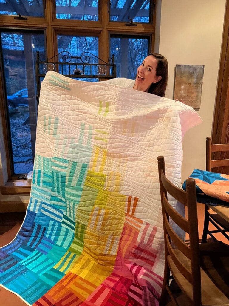 Improvistational pieced quilt in rainbow palette