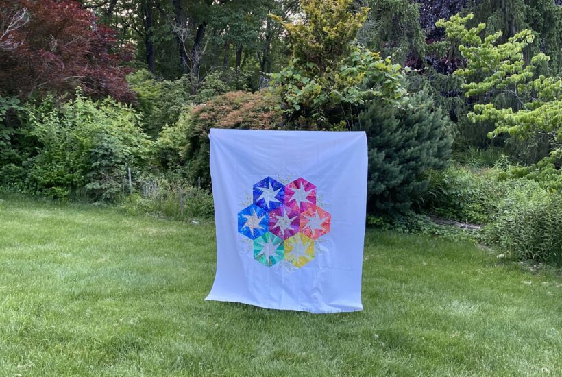 Image shows Rebecca Bryan's Scrappy Whirligig quilt, one of our free quilt patterns