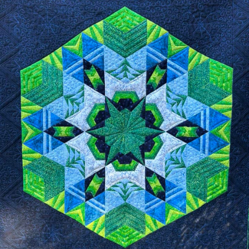 Cosmos quilt made with hexagons.