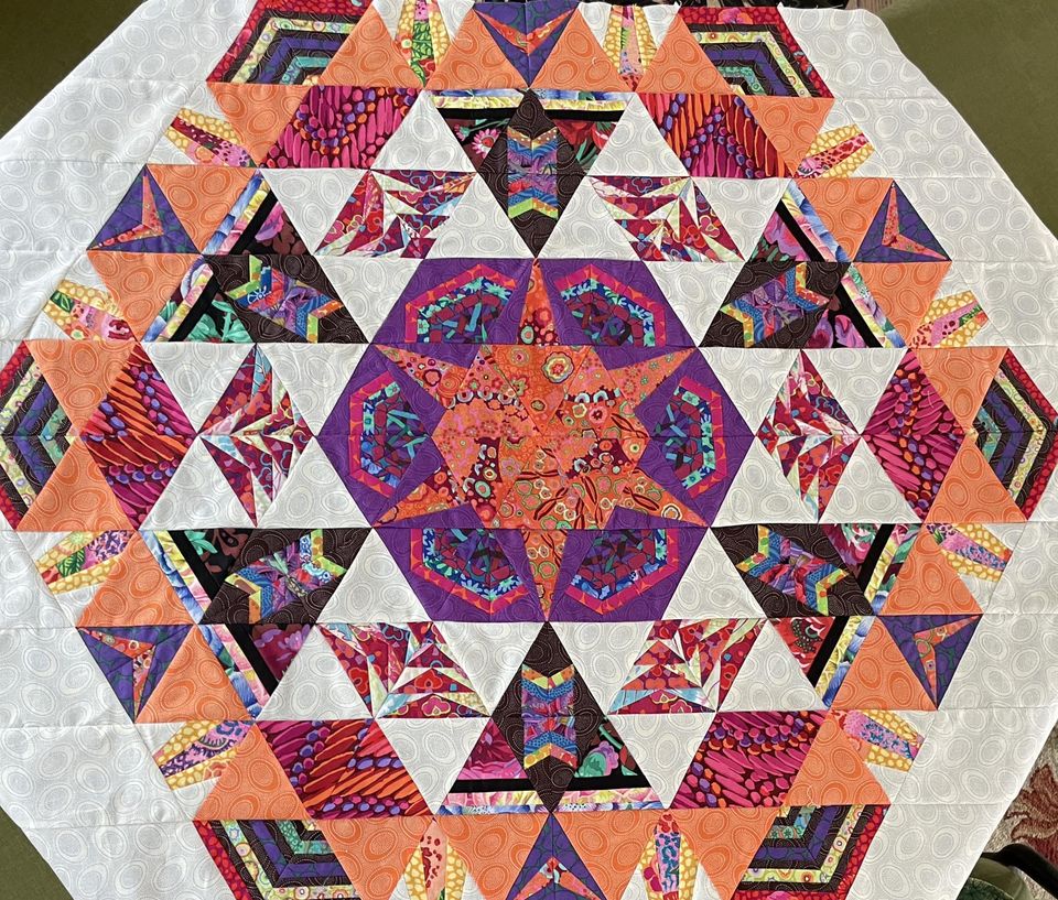 busy members make triangle blocks cosmos quilt finish by Sherry B.