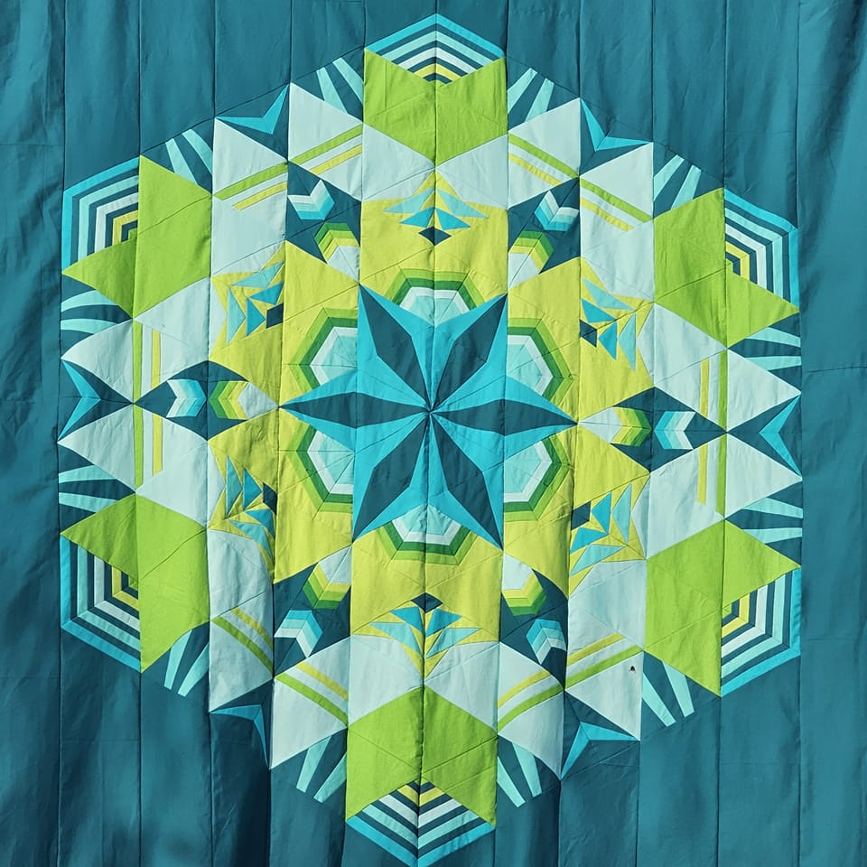 Cosmos Block of the month made by member Lynne S.radial design quilt in a hexagons layout