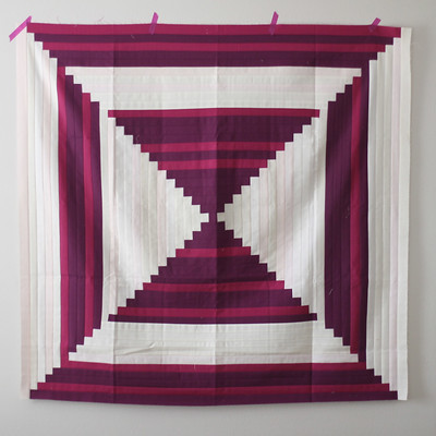 Courthouse steps is a modern two color quilt pattern made in red and white log cabin blocks