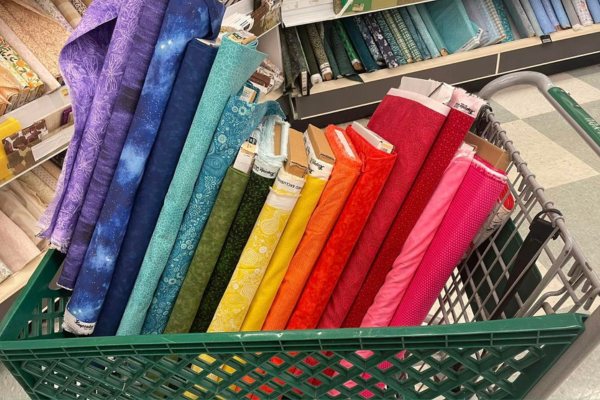 Celebrating quilty progress with a shopping cart full of fabric choices for the Aurora BOM quilt.