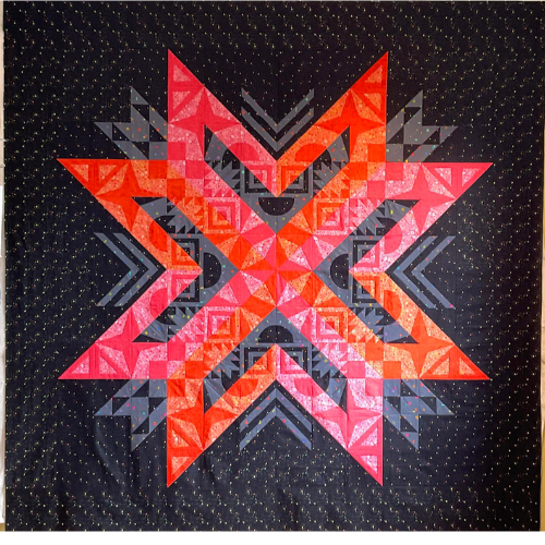 Debbie U., Aurora BOM maker, used bold warm colors for her quilt.