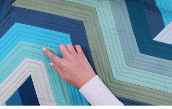 Quilting to finish top with straight line quilting, perfect for an amazing jelly roll quilt pattern with a modern slant.