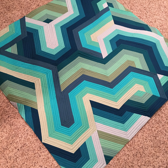 My Pathways quilt in olive, teal and blue jelly roll strips.