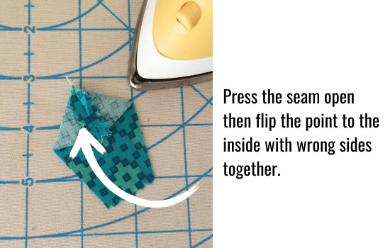 Press the seam open then flip the point to the inside with wrong sides together.