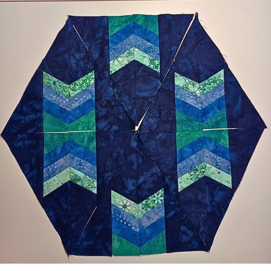 BOM blocks close up in navy blue, teal and teal green fabrics.