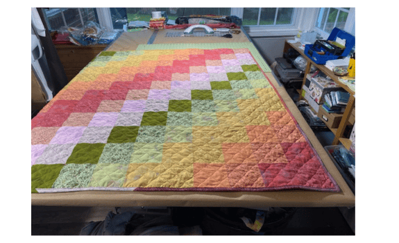 square patchwork quilt in pastel colors