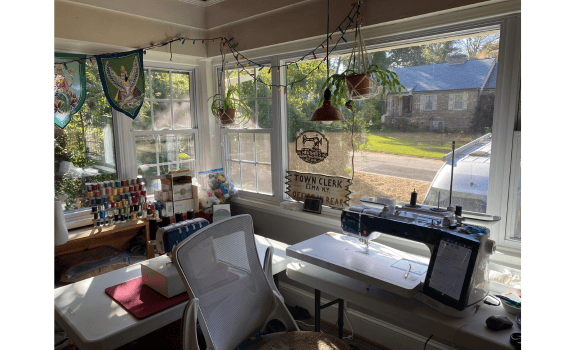 member spotlight on Heather O. sewing studio - windows, sewing machine and thread with lots of plants.