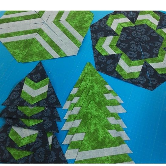 BOM blocks close up in navy blue and green fabrics.
