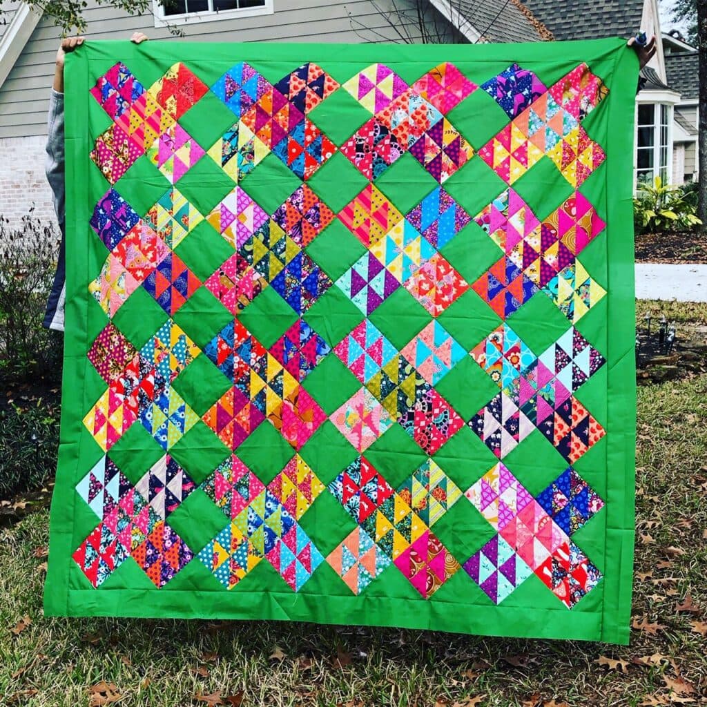 Hello houston quilt made with scrappy half square triangles