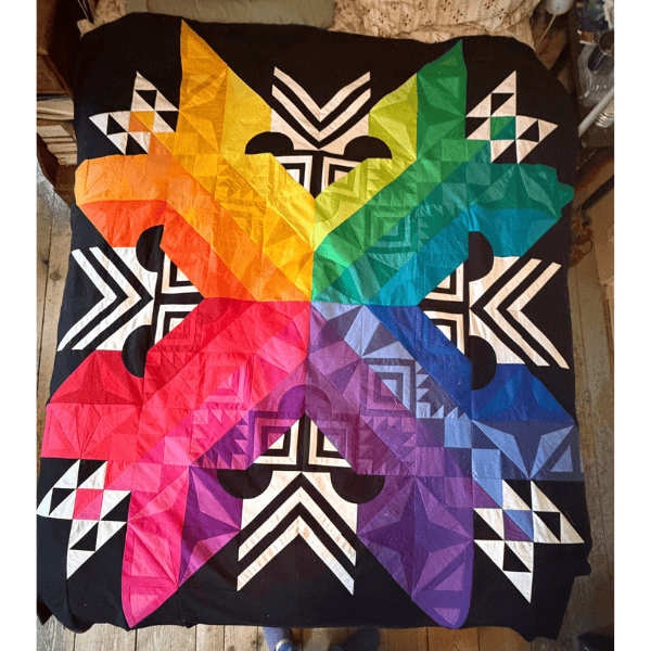 Aurora BOM quilt made with with a rainbow color palette.