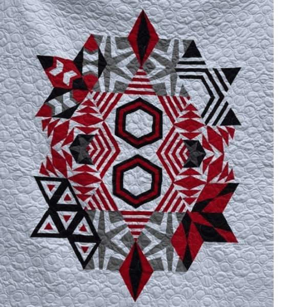 Making progress with muscle memory makes it possible to finish a freezer paper pieced quilt.