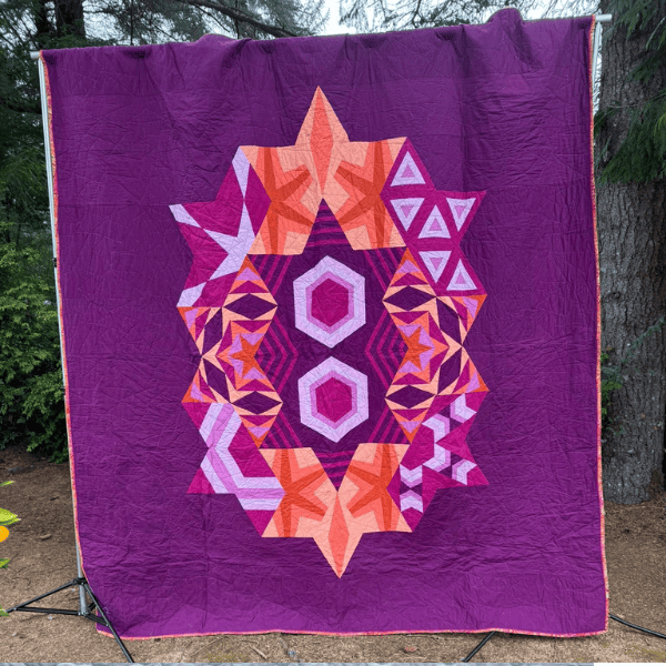 Making progress with muscle memory makes it possible to finish a freezer paper pieced quilt, like the ECHO BOM in coral and magenta colors.