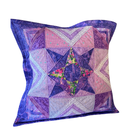 Duayna made her first freezer paper piecing project in purples and pinks for a pillow.